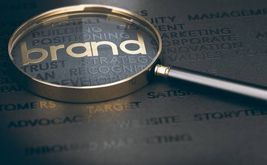 Magnifying glass over the word brand