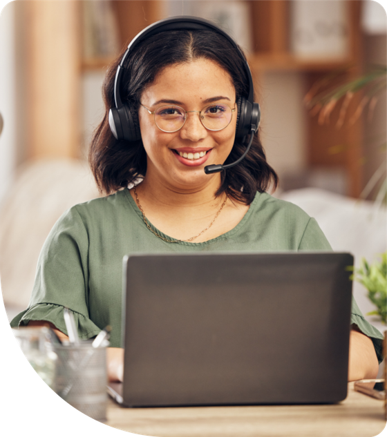 Marketing specialist with a headset working at a laptop