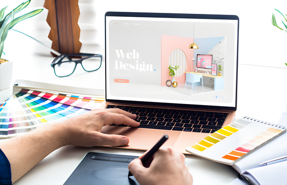 Laptop showing a web design project on a designer desk